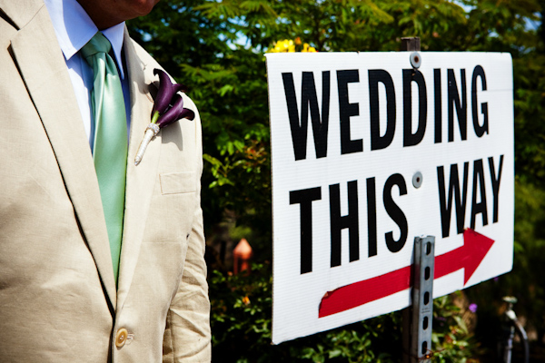 alternative portrait of groom and sign towards wedding - photo by Southern California wedding photographers Callaway Gable