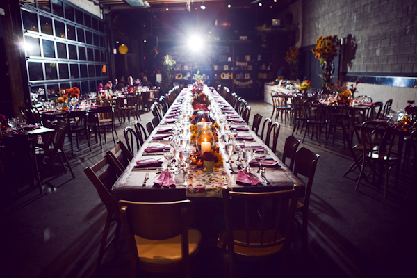 a long table in the center of a colorful warehouse reception site - vintage LA wedding at The Smog Shoppe photo by top Orange County wedding photographer Duke Images