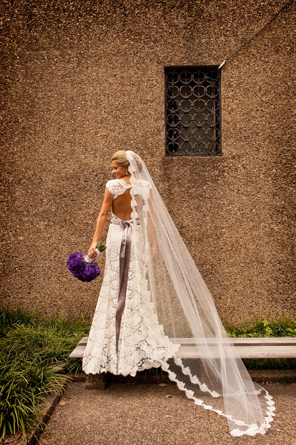 bride wearing a beautiful vintage style white lace wedding dress and full-length mantilla style veil holding a purple bouquet - photo by Washington DC based wedding photographers Holland Photo Arts