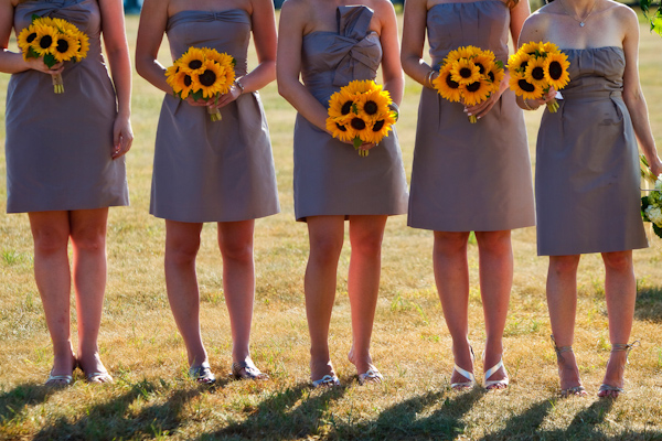 bridesmaids wearing blue-gray dresses holding yellow sunflower bouquets - photo by Washington DC based wedding photographers Holland Photo Arts