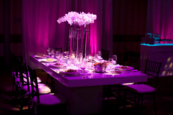 photo by Denver based wedding photographer Jared Wilson - purple lighting - reception tabletop details with orchid centerpiece