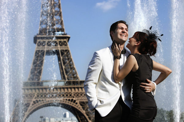 adorable bride and groom in front of the eiffel tower - photo by destination wedding photographer Jerry Ghionis