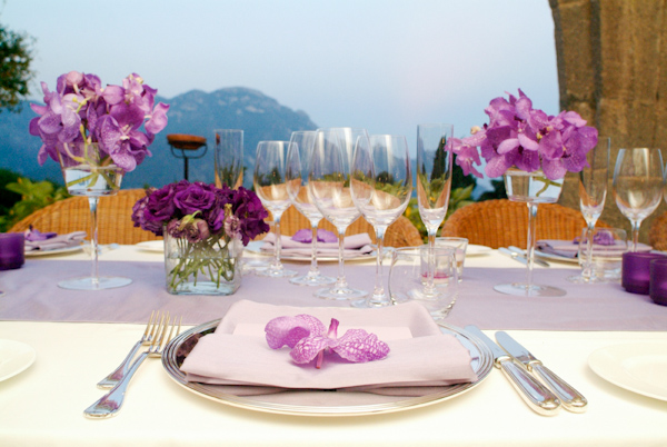 beautiful outdoor reception table setting decorated with lavender and purple flowers and candles - photo by Italian wedding photographer JoAnne Dunn