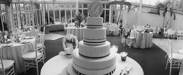 photo by New York City based wedding photographer Karen Hill - black and white image - reception - four tier wedding cake with monogram cake topper