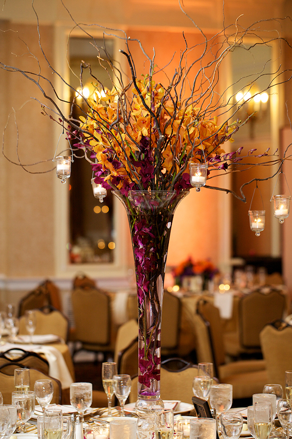 purple and yellow centerpiece with branches and hanging candles - wedding photo by top Philadelphia based wedding photographers Langdon Photography