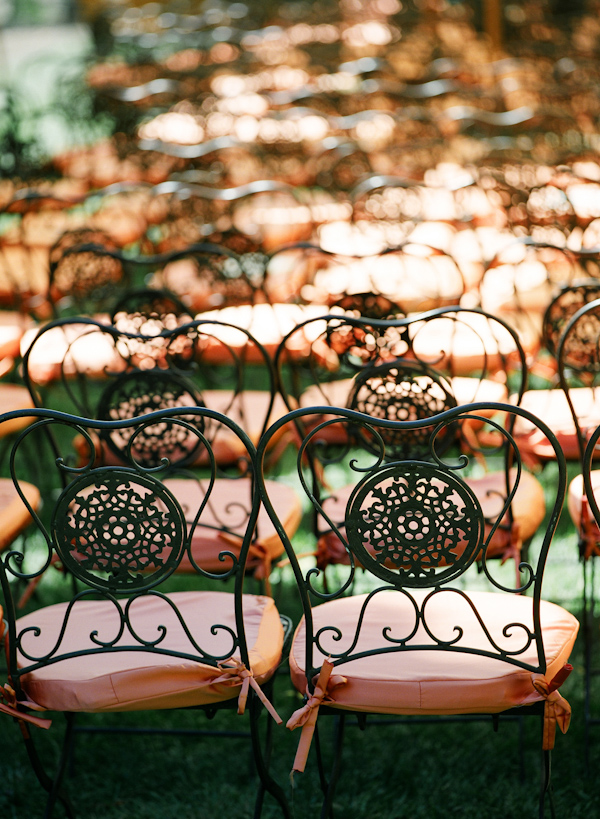 coral chair covers on wrought iron chairs - wedding photo by Meg Smith Photography