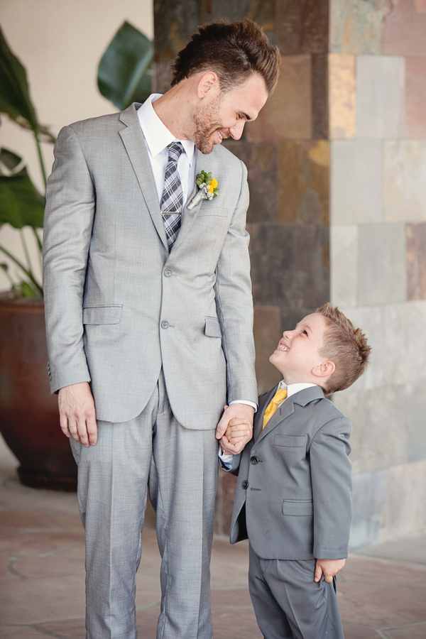 Cute photo of the groom and little boy wearing gray suits - Photos by April Smith & Co.