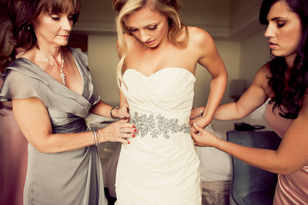 Bride getting dressed on her wedding day - wedding photo by Focus Photography