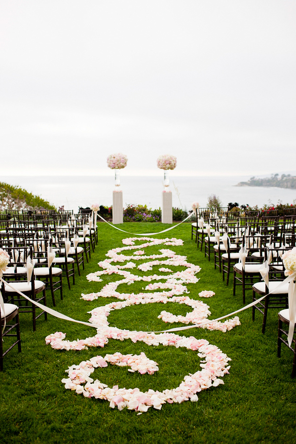 Outdoor aisle with light pink and white florals and petal decoration - wedding photo by Focus Photography