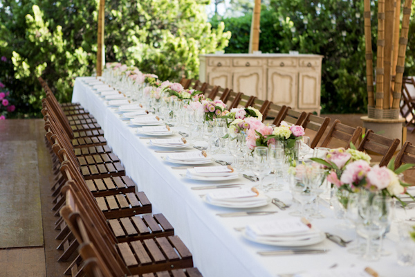 Beautiful reception seating with white accents and pink florals - wedding photo by Ian Holmes