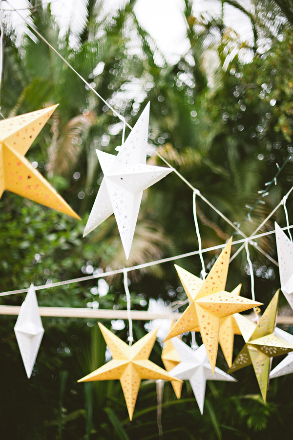 Hanging yellow and white star decor for Mexico destination wedding - Photo by Jillian Mitchell