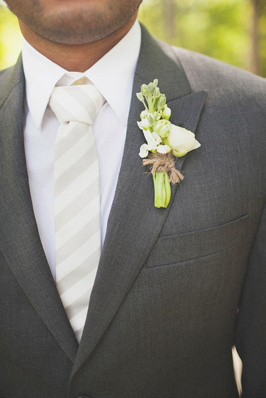 White boutonniere on gray suit tied with burlap - Photo by The Schultzes
