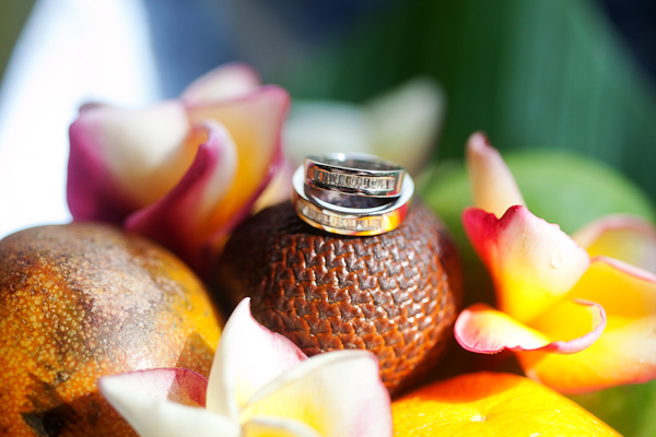 rings rest on yellow flower arrangement - traditional Indonesian wedding in Bali - photo by Portland wedding photographer Bunn Salarzon