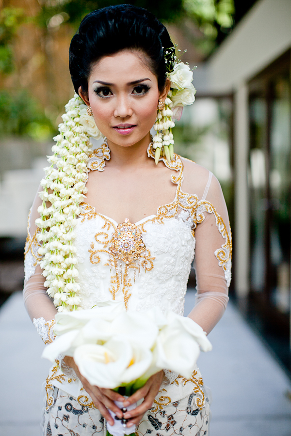bride in Indonesian wedding garb with lily bouquet - traditional Indonesian wedding in Bali - photo by Portland wedding photographer Bunn Salarzon