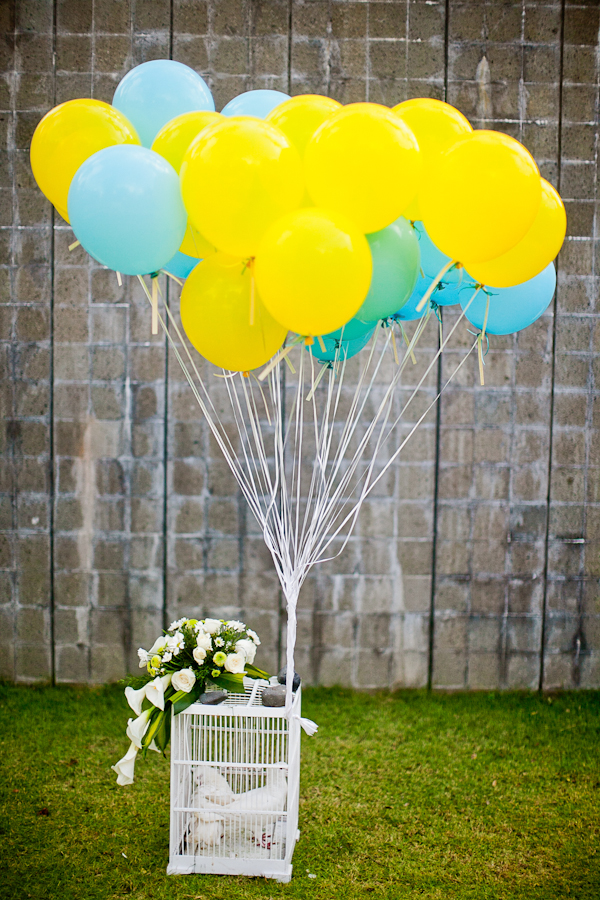 yellow and light blue balloons with doves to release after the wedding - traditional Indonesian wedding in Bali - photo by Portland wedding photographer Bunn Salarzon