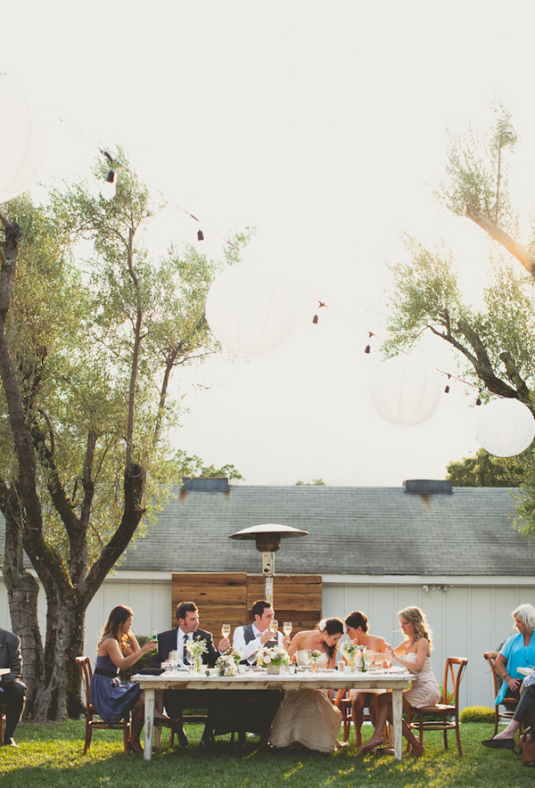 bridal party at vintage table between trees in outdoor reception - warm, sunny, Sonoma California vineyard wedding photo by California wedding photographers EP Love