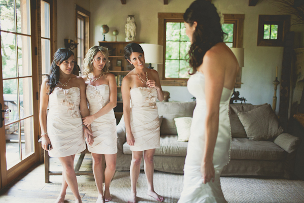 bridesmaids in short ivory dresses look at bride - warm, sunny, Sonoma California vineyard wedding photo by California wedding photographers EP Love