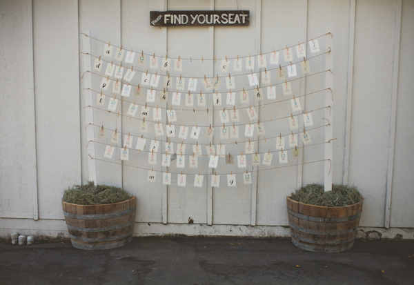 poles with twine hanging provide place cards with vintage sign - warm, sunny, Sonoma California vineyard wedding photo by California wedding photographers EP Love