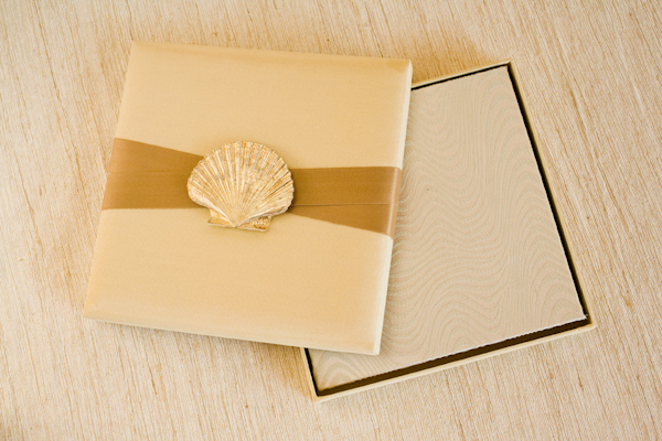 ivory wedding invitation cover with gold ribbon and seashell design - photo of wedding invitation designed by Flite Design