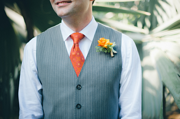 detail shot of groom's orange boutonniere, gray pinstriped vest, and orange tie -  Sayulita, Mexico destination wedding photo by Mexico wedding photographer Jillian Mitchell