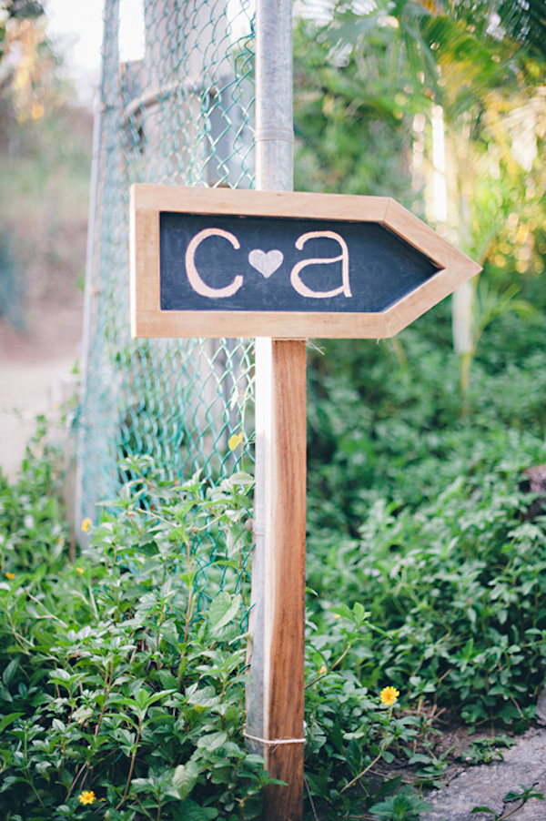 arrow shaped chalkboard sign with the couples initials - Sayulita, Mexico destination wedding photo by Mexico wedding photographer Jillian Mitchell