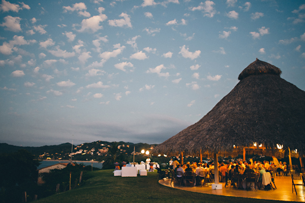 outdoor reception site with grass room and cliffside view - Sayulita, Mexico destination wedding photo by Mexico wedding photographer Jillian Mitchell