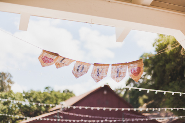 Rustic burlap Love sign with red hearts - Photo by Michelle Warren Photography