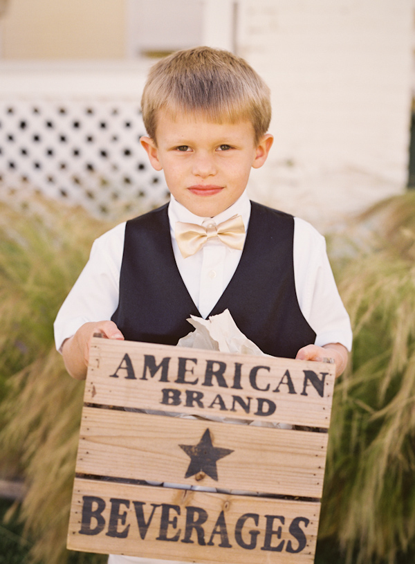 Cute little boy in tux holding beverage cart - Photo by Michelle Warren Photography