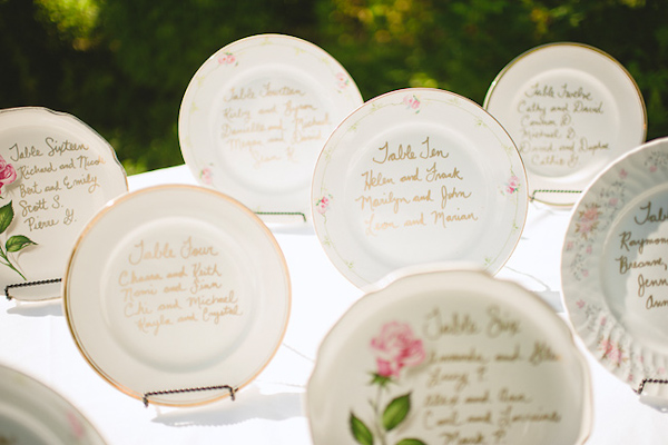 Beautiful vintage inspired plates with hand-written table assignments - Photo by Nordica Photography