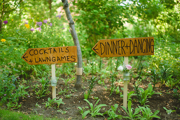 Rustic wedding reception signs leading to Dinner + Dancing and Cocktails + Lawngames - Photo by Nordica Photography