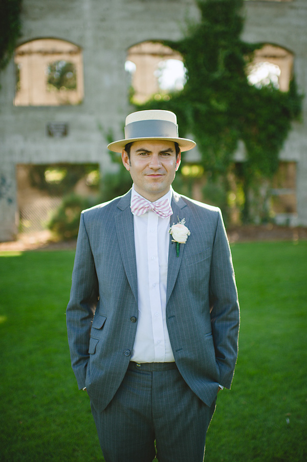 Handsome groom wearing gray suit, pink bowtie and top hat - Photo by Nordica Photography