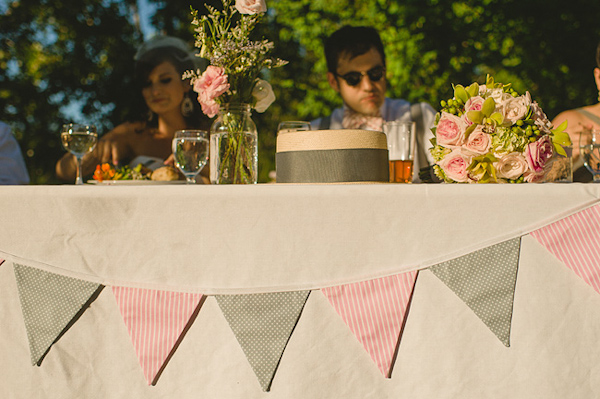 Pink and green bunting as head table decor - Photo by Nordica Photography