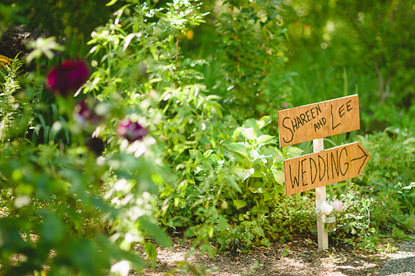 Rustic sign leading to wedding ceremony and reception - Photo by Nordica Photography