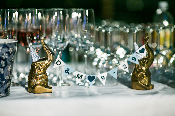 Elephants with miniature, customized bunting as wedding reception decor - Photo by Sarah Tew Photography