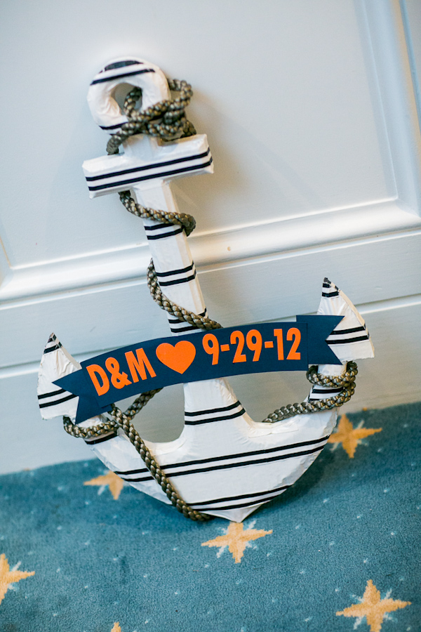 Navy, orange and white nautical-inspired anchor with couple's initials and wedding date - Photo by Sarah Tew Photography