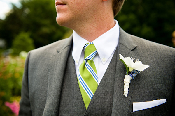 groom in gray suit with chartreuse and blue tie - white and light blue boutonniere -  preppy New York Sagamore resort wedding photo by New York wedding photographer Tracey Buyce