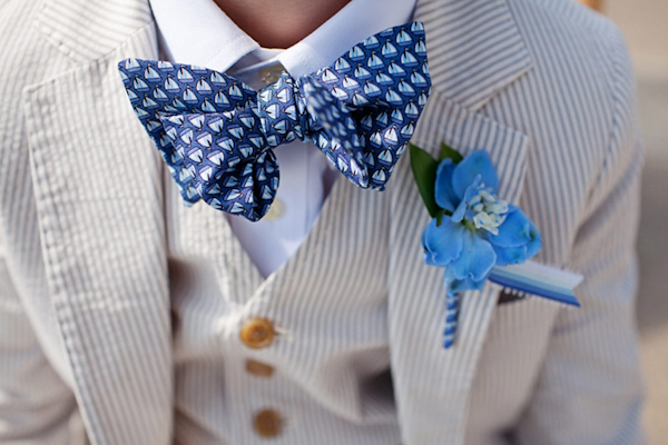 child's suit with dark blue sailboat bow tie and light blue boutonniere - preppy New York Sagamore resort wedding photo by New York wedding photographer Tracey Buyce
