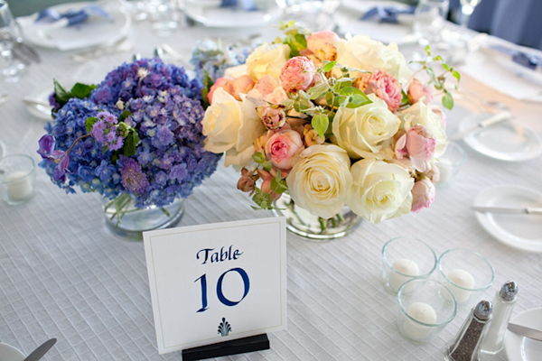 table number and blue and white flowers on white table cloth - table setting - preppy New York Sagamore resort wedding photo by New York wedding photographer Tracey Buyce