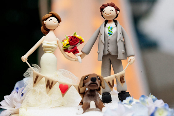 cute sculpted cake topper of the couple and their dog - preppy New York Sagamore resort wedding photo by New York wedding photographer Tracey Buyce