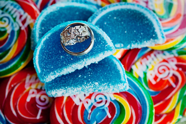 rings rest on colorful candy at the candy bar - preppy New York Sagamore resort wedding photo by New York wedding photographer Tracey Buyce