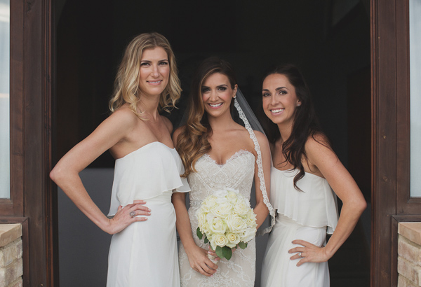 Beautiful bride wearing ivory while her bridesmaids wear white - Photo by Whitewall Photography