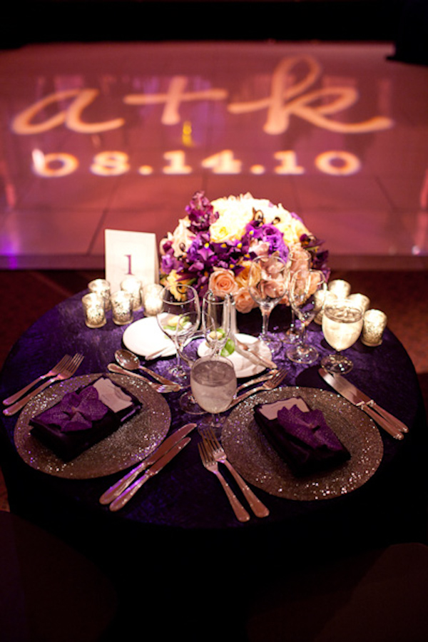 the reception sweetheart's table decorated with purple linens, silver dishes, and purple and white flowers - photo by Washington DC wedding photojournalist Paul Morse