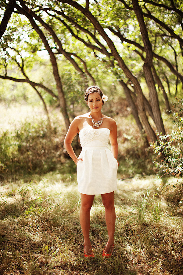 the beautiful bride poses for a portrait in the trees - photo by Dallas based destination wedding photographer Poser