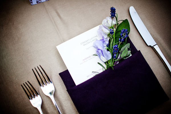 reception decor details - dark purple napkin folded with ivory menu inserted with lavendar and blue floral accent - photo by New Mexico based wedding photographers Twin Lens