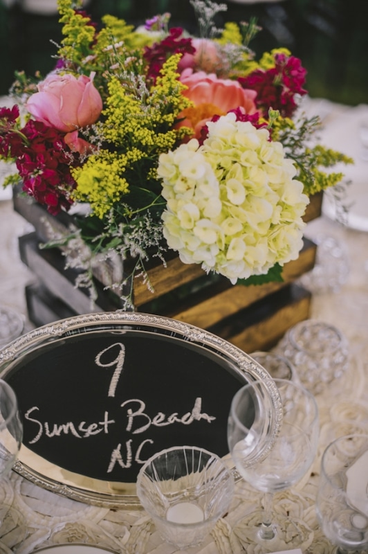 floral table centerpiece with chalkboard table numbers, photo by The Oberports