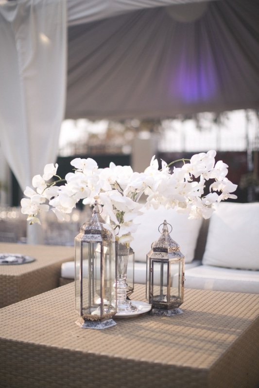 white orchids in lantern reception decor, photo by Melissa Jill Photography