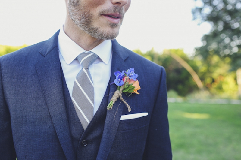 groom in blue suit with boutonniere, photo by Christina Carroll Photography