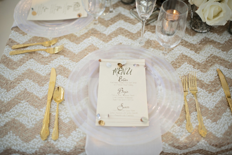 place setting with gold chevron print and gold flatware, photo by Kristen Weaver Photography
