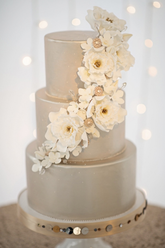 silver tiered wedding cake with white florals on metallic cake stand, photo by Kristen Weaver Photography
