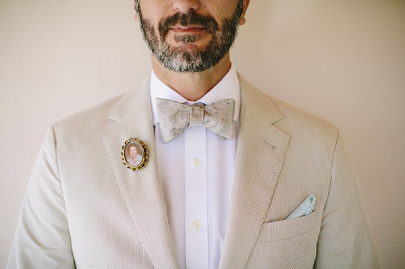 groom in bow tie with teal handkerchief and small photo heirloom pin, photo by Adam Alex